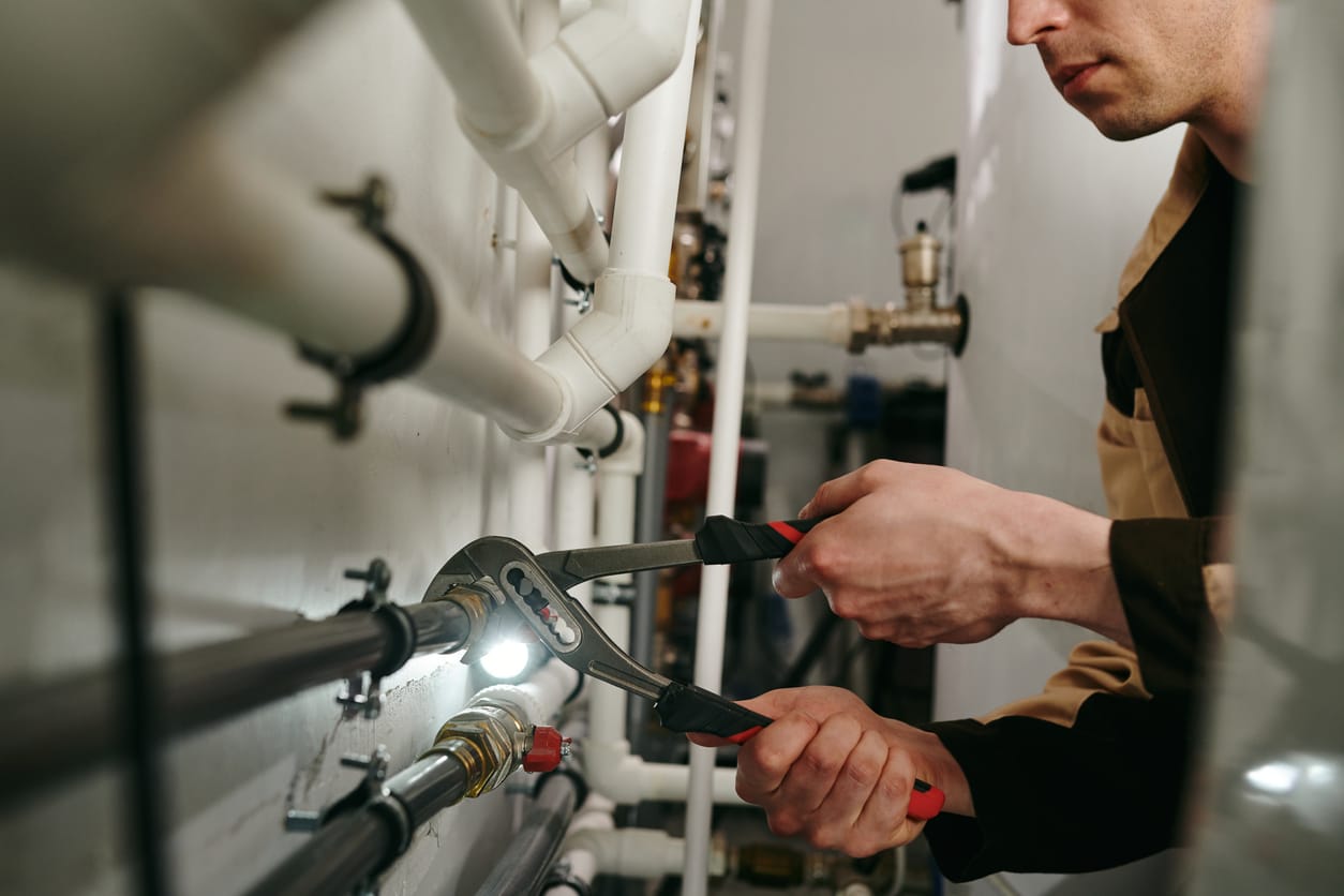 Plumbers maintaining commercial plumbing pipes in Acworth