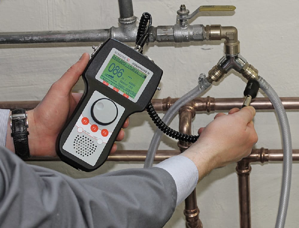 Plumber testing pipes with electronic leak detection equipment in Acworth