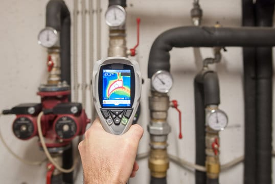 Plumber using a thermal imaging camera to inspect pipes in Acworth
