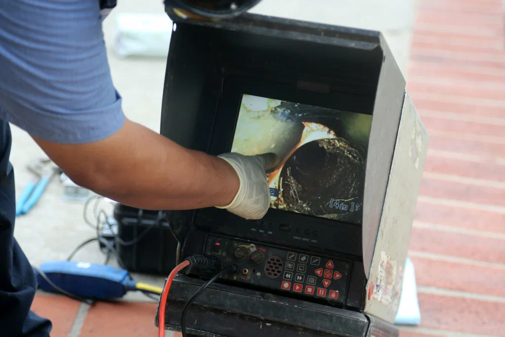Technician viewing a drain inspection camera in Acworth