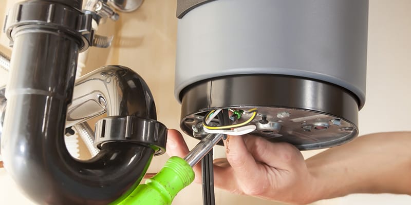 Technician repairing the heating element of a water heater in Acworth